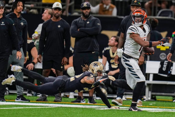 Cincinnati Bengals wide receiver Ja'Marr Chase (1) breaks a tackle by New Orleans Saints safety Tyrann Mathieu (32) to score a touchdown late in the fourth quarter. © Cara Owsley/The Enquirer / USA TODAY NETWORK